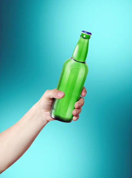 Hand holding a bottle. Stock Image