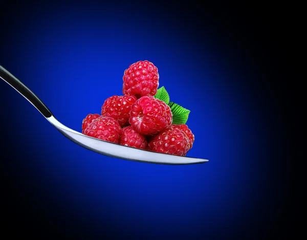 Ripe raspberries in a spoon — Stock Photo, Image