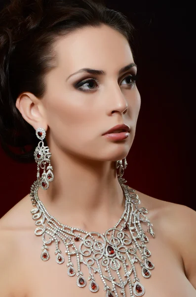 Woman in jewellery pendant and earrings — Stock Photo, Image