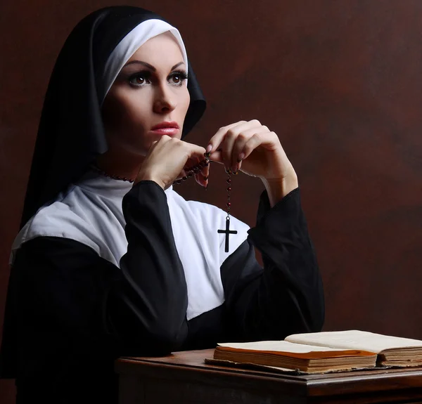 Young attractive nun praying — Stock Photo, Image