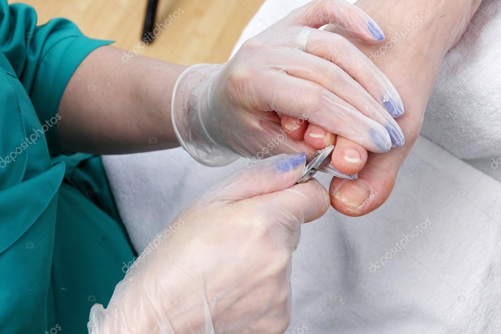 Peeling feet pedicure procedure Stock Photo by ©nikolasvn 69905557