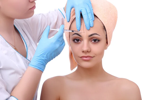 Beautiful woman gets an injection in her face. — Stock Photo, Image