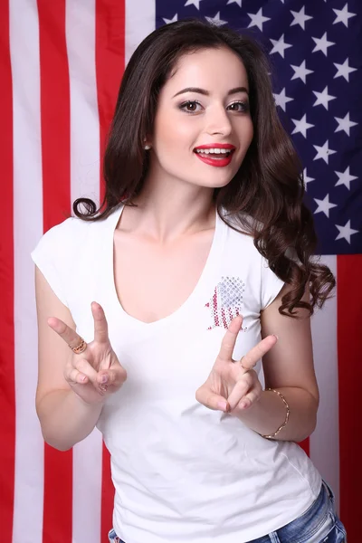 Sexy young woman posing over american flag background — Stock Photo, Image