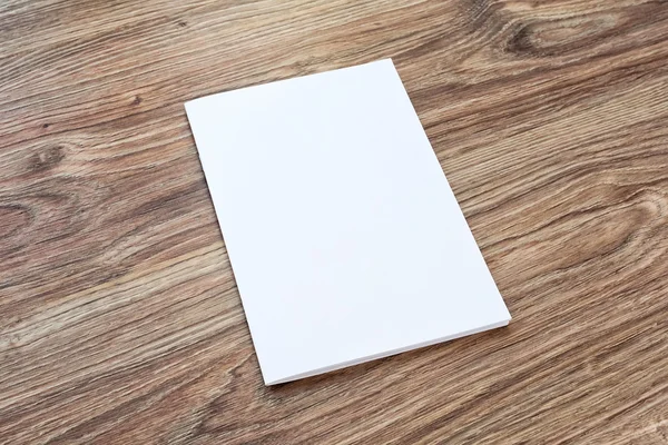 Blank of brochure is on a wooden desk. — Φωτογραφία Αρχείου