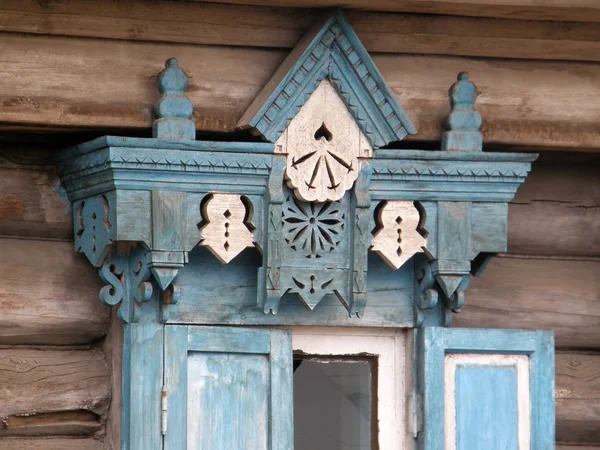 The windows with beautiful architraves in old wooden house. Ulan — Stock Photo, Image