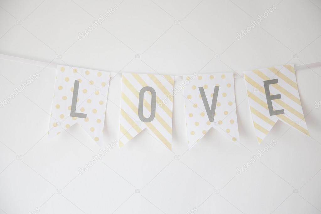 LOVE 4 alphabets decorative buntings on white wall