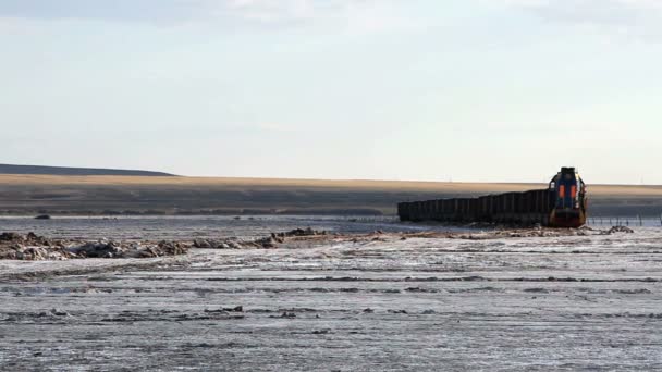 Old rusty train on the salt lake Baskunchak — Stock Video