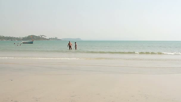 Неопознанный человек, идущий по пляжу Палолем — стоковое видео