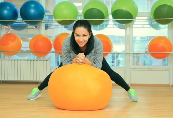 Young female with fit ball in sport center — Stock Photo, Image