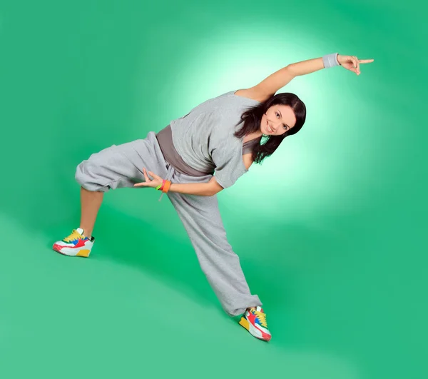 Attractive young female in stretching over green — Stock Photo, Image