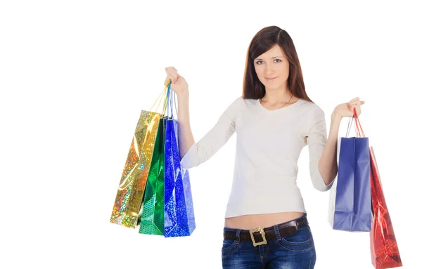 Pretty brunette with shopping bags over white — Stock Photo, Image