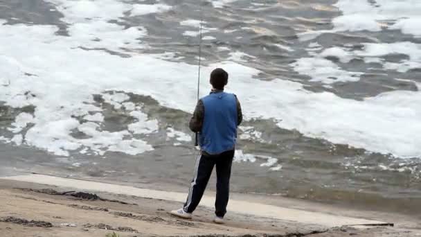 Joven pescando en un lago — Vídeos de Stock