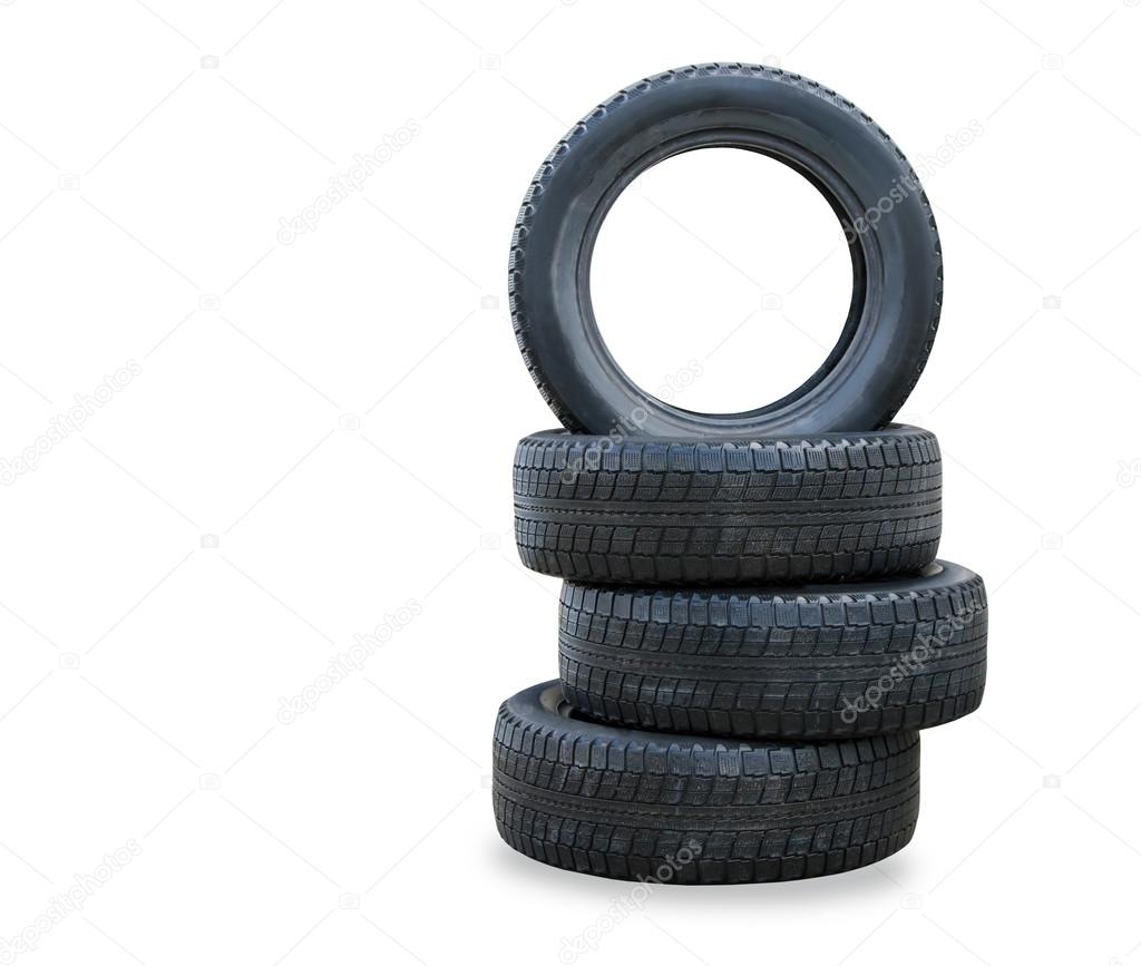 The stack of four winter new tires over white