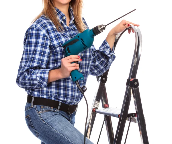 Woman holds a drill, isolated on a white background — Stock Photo, Image