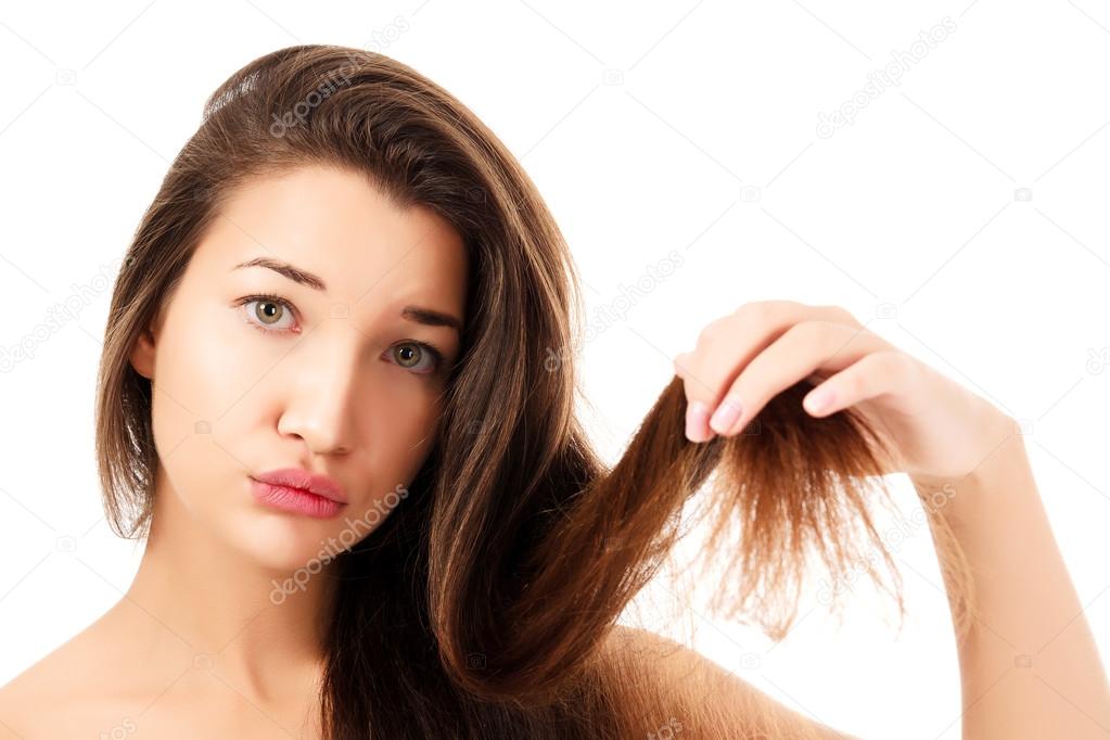woman showing her fragile hair, white background, copyspace.