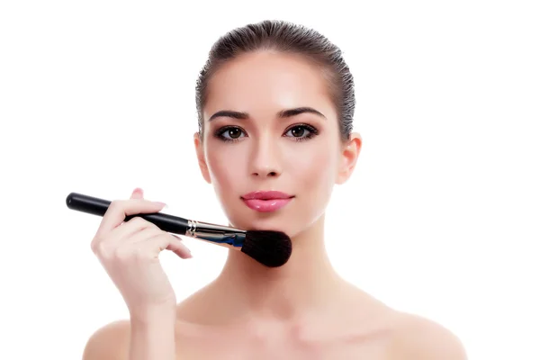 Pretty woman with makeup brush — Stock Photo, Image