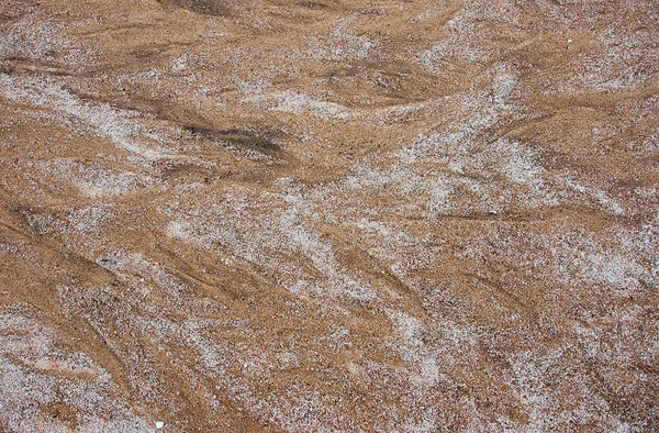 Fondo abstracto en forma de manchas negras en la arena . Fotos de stock libres de derechos