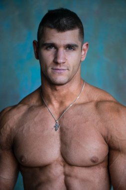 Stüdyoda poz veren kaslı adamın portresi.