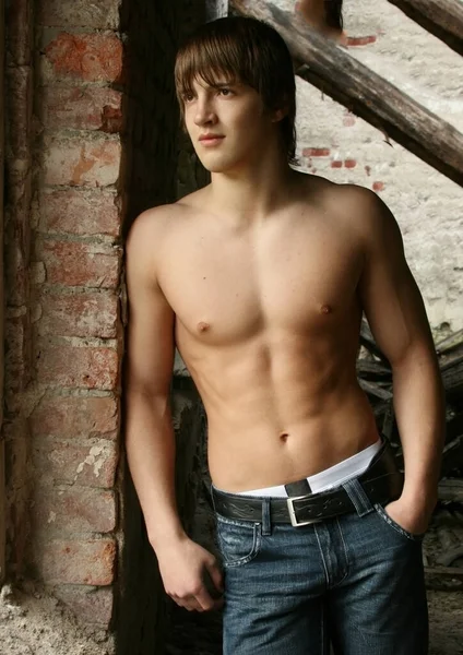 Muscled male model posing in old building