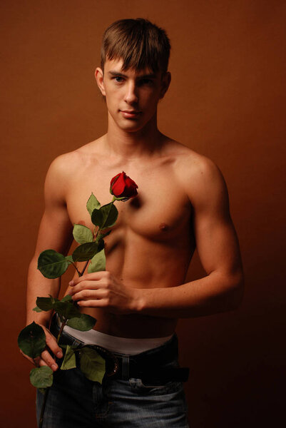 Fitness model posing in studio with a rose