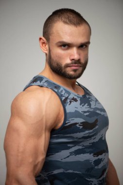 Stüdyoda poz veren kaslı adamın portresi.