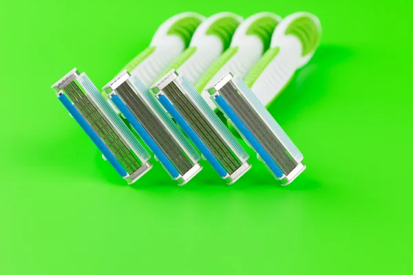 Green razor on green background — Stock Fotó