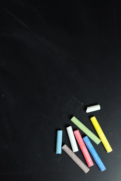 Multicolor chalk on chalkboard — Stock Photo, Image