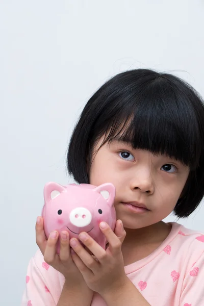 Asian child with piggy bank — Stock Photo, Image