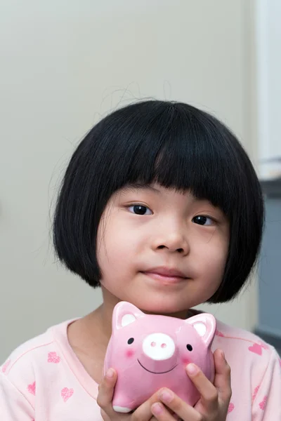 Asian child with piggy bank — Stock Photo, Image