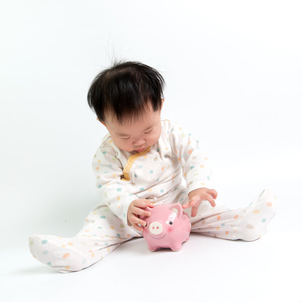Asian baby with piggy bank