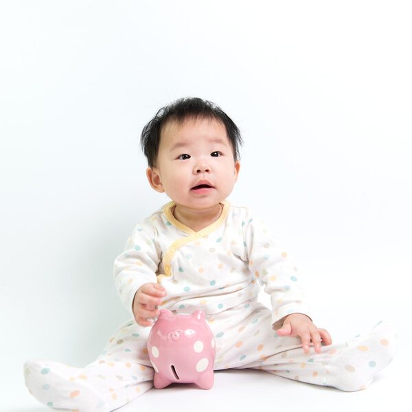 Asian baby with piggy bank