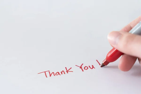 Hand writing thank you note using red marker pen Stock Photo