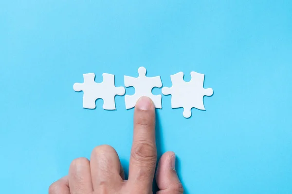 Business merging concept using white jigsaw puzzle — Stock Photo, Image