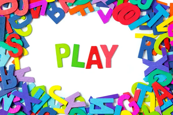 Play spelled out with colourful wood blocks — Stock Photo, Image