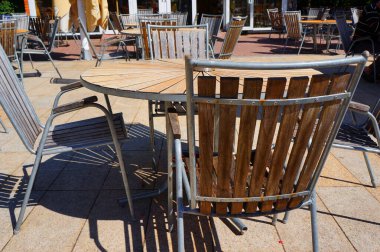 Wooden chairs and wooden circle table in beach cafe in Palanga, Lithuania.        