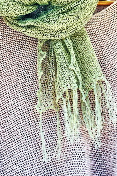 Linen knitted scarf and knitted blouse on hanger. Ladies\' summer wear.