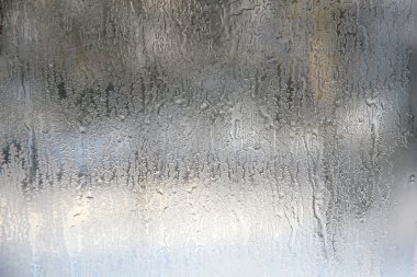 Frozen drops on frosted glass. Winter textured background. clipart