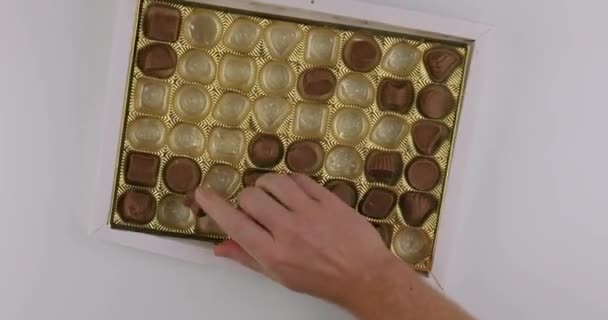 Bonbons auf verrückte Art und Weise aus der Schachtel pflücken — Stockvideo