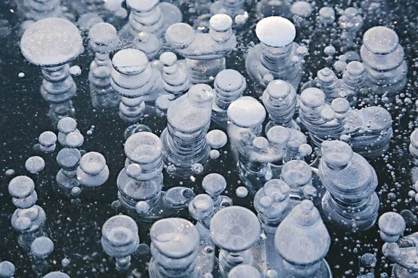 Winter ice with gas bubbles trapped inside — Stock Photo, Image