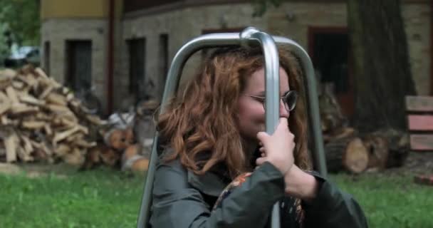 Young woman spinning on a playground object — Stock Video