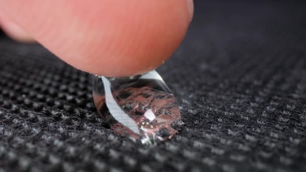 Gota de agua macro tocada con el dedo — Vídeos de Stock