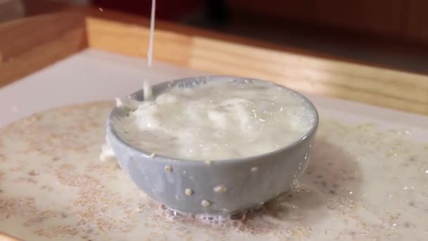 Cereals milk poured in a bowl in slow motion — Stock Video