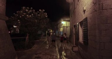 Kotor, Montenegro - July 26, 2024: Walking in Kotor old medieval town center, tourist destination with spectacular stone building architecture and cobble streets, narrow alleys in the evening