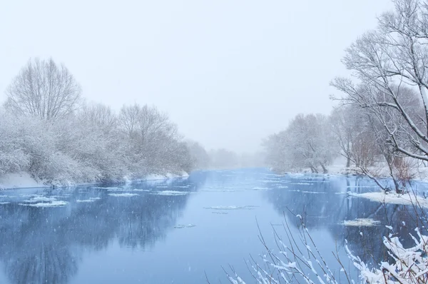 Зимняя река в снежную погоду — стоковое фото