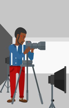 Photographer working with camera on a tripod.