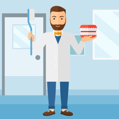 Dişçi diş çene modeli ve diş fırçası.