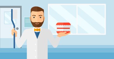 Dişçi diş çene modeli ve diş fırçası.