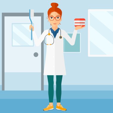 Dişçi diş çene modeli ve diş fırçası.