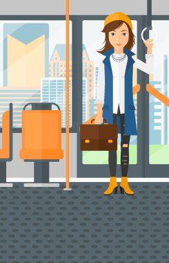 Woman standing inside public transport.