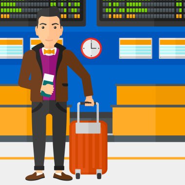 Man standing with suitcase and holding ticket.